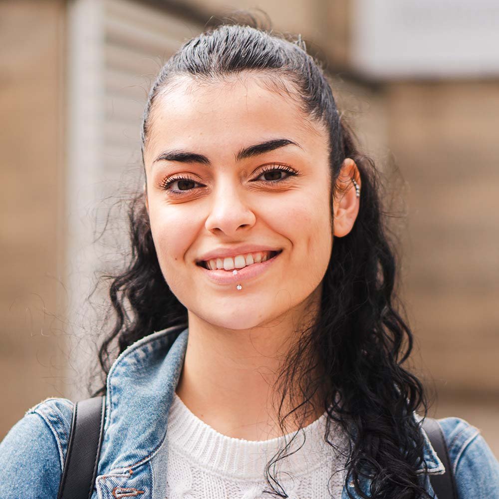 pretty hispanic female student smiling and looking CFSPSYT